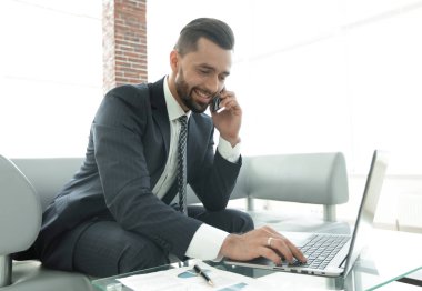 Smartphone üzerinde konuşmak ve metin dizüstü bilgisayarda yazarak işadamı