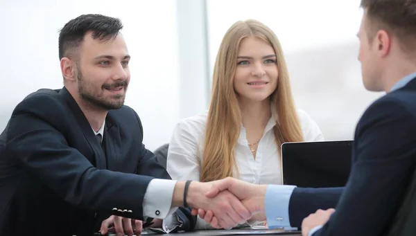 Handshake parceiros financeiros sentados à mesa — Fotografia de Stock