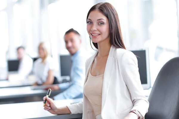 Portrait of a female assistant sitting at a Desk — Stock Photo, Image