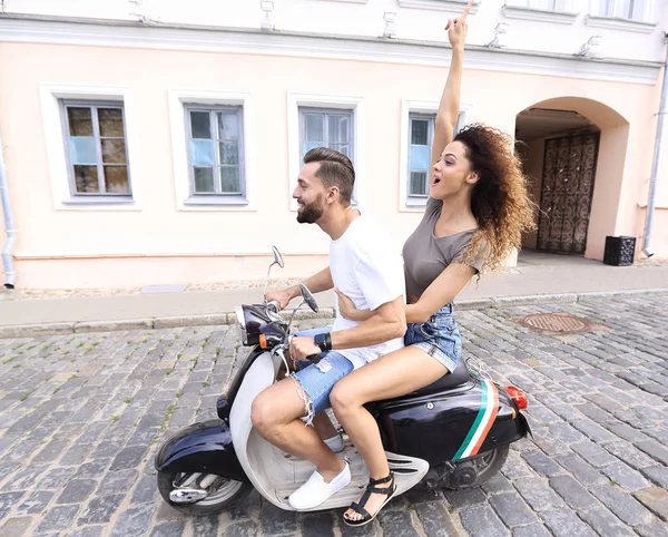 Full length side view of happy couple riding on retro motorbike — Stock Photo, Image