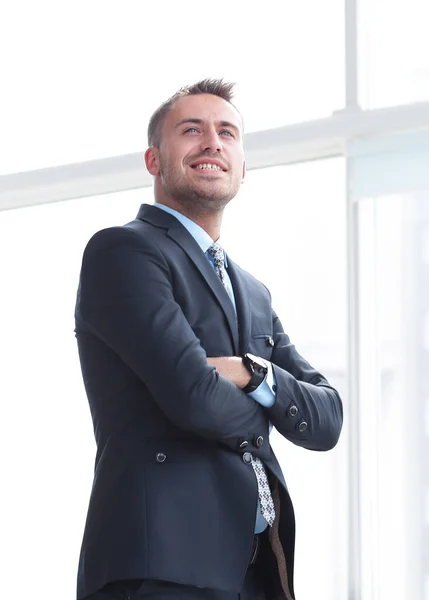 Portrait of confident businessman looking out the window of the office. — Stock Photo, Image