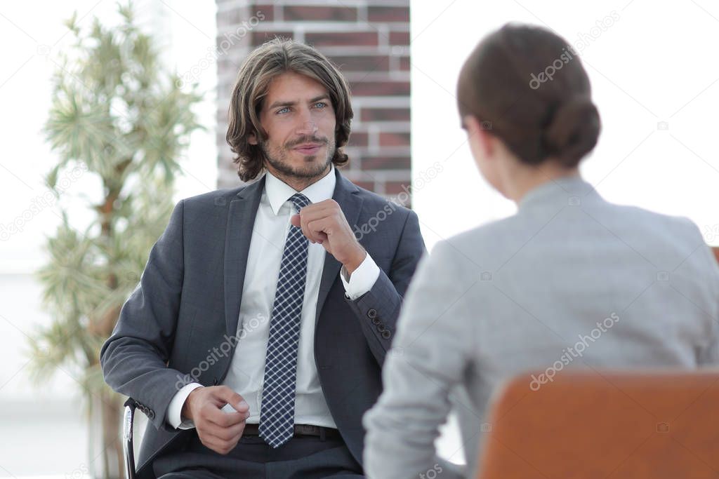 A relaxed conversation of a man and a woman in the office