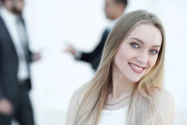 Close-up portrait of a young woman against the background of colleagues — Stock Photo, Image