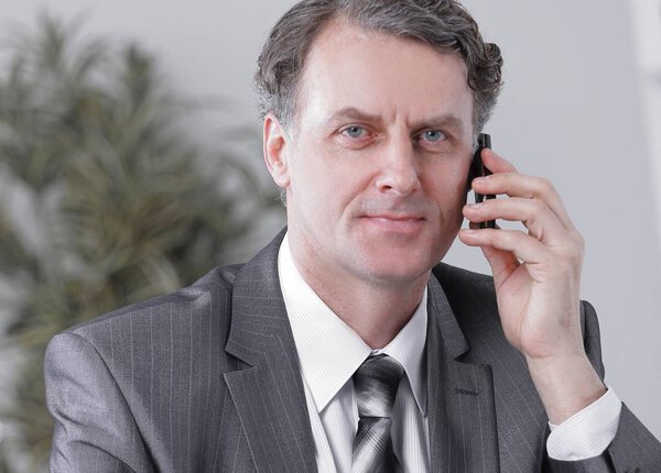 Businessman having phone call conversation at workplace