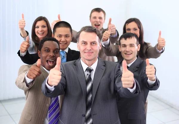 Happy business team holding thumbs up — Stock Photo, Image