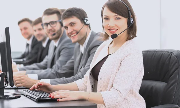 Female customer service representative and colleagues in the call center — Stock Photo, Image