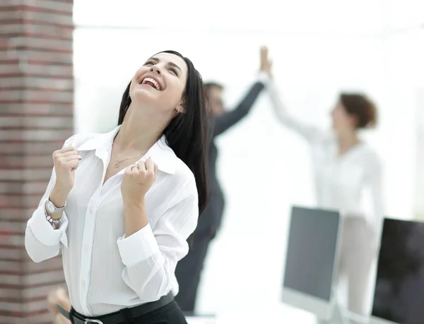 Gelukkig jonge zakenvrouw op een achtergrond wazig office. — Stockfoto