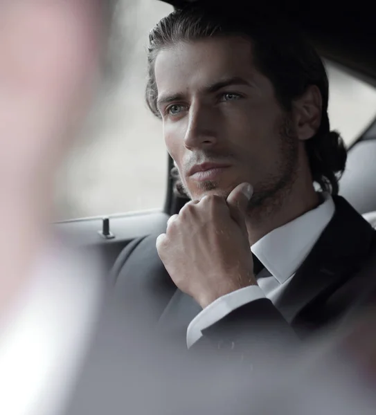 Hombre de negocios sentado en su coche . — Foto de Stock