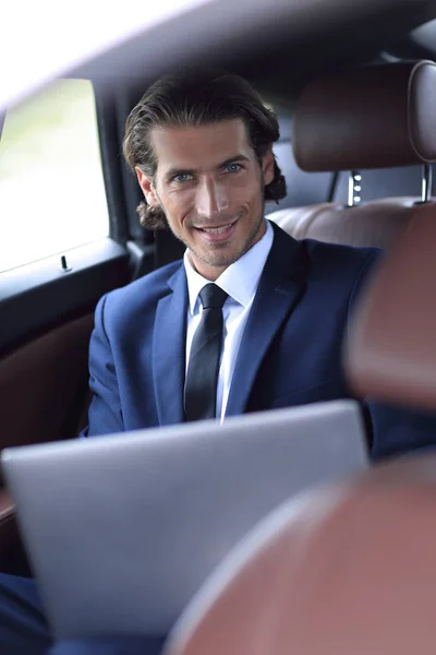 Hombre trabajando en el ordenador portátil mientras está sentado en el coche —  Fotos de Stock