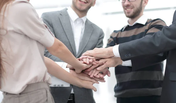 Business team standing joining hands together