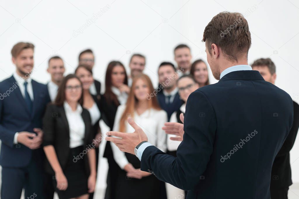 businessman makes a speech to his team.