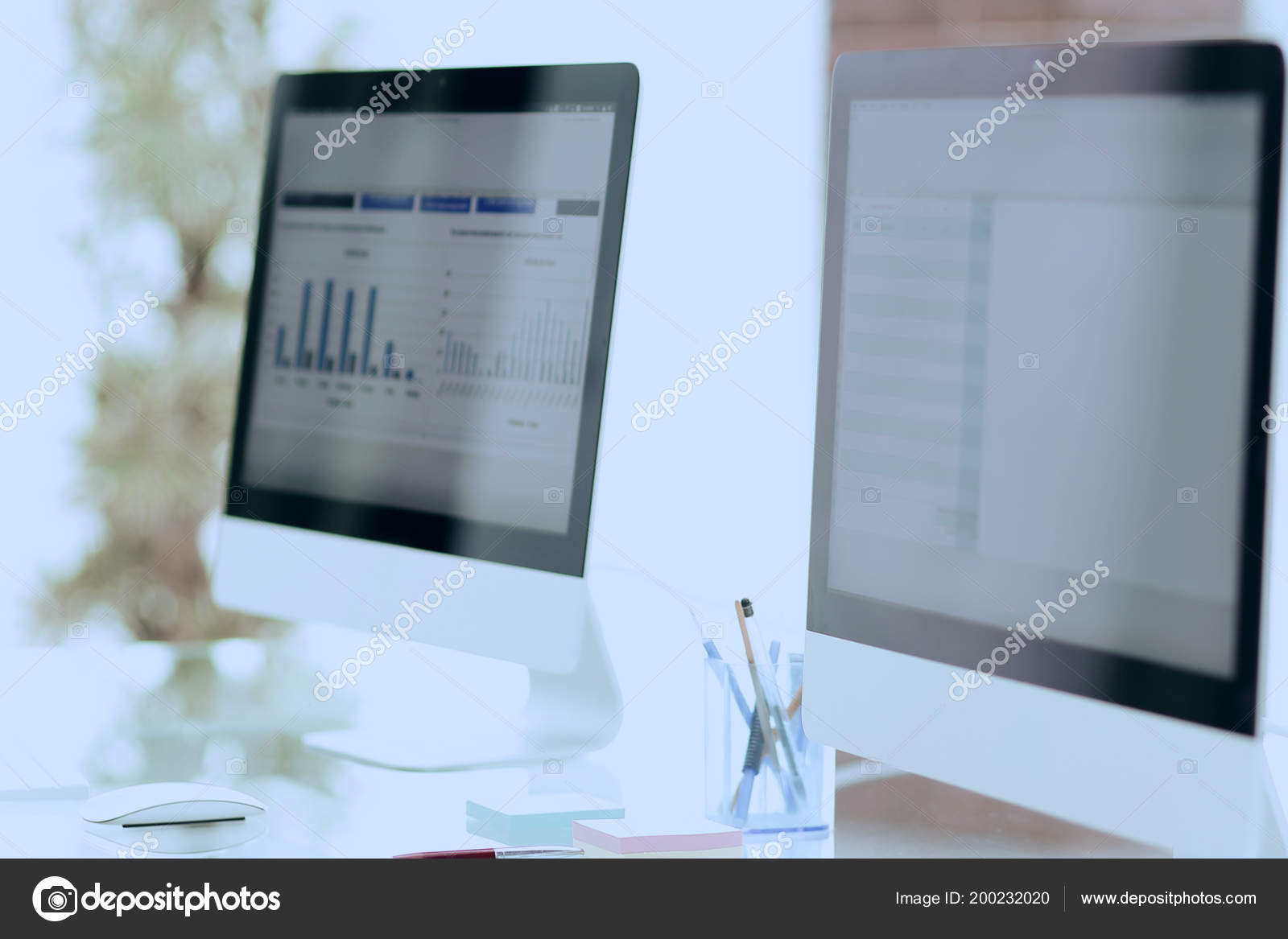 Close-up of the screens of personal computers on a modern workplace in ...