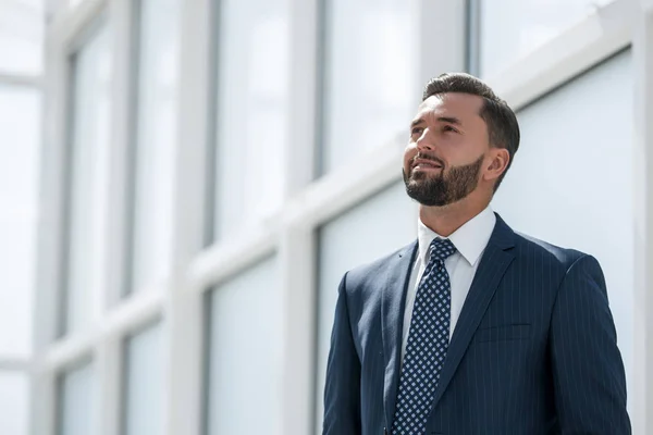 Dreaming of a businessman standing in new office — Stock Photo, Image