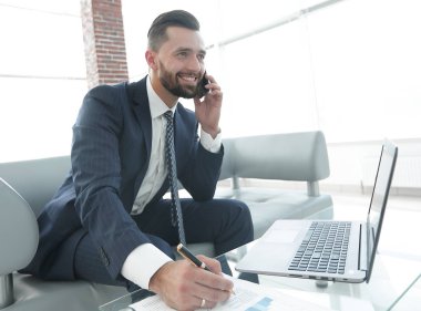 İşadamı Smartphone'da mali grafikler hakkında konuşmak.