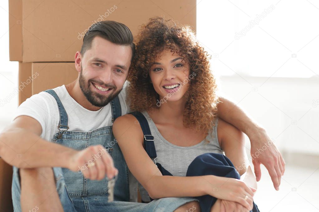 Close-up of a young couple on a background of cardboard boxes