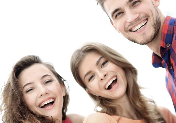 Closeup of three young people smiling on white background — Stock Photo, Image