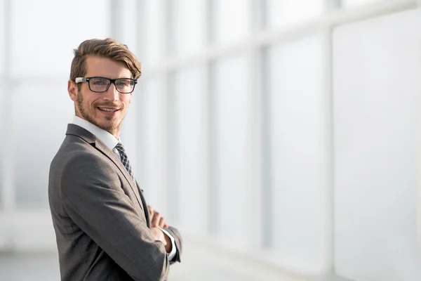 Young businessman standing near the office window — Stock Photo, Image