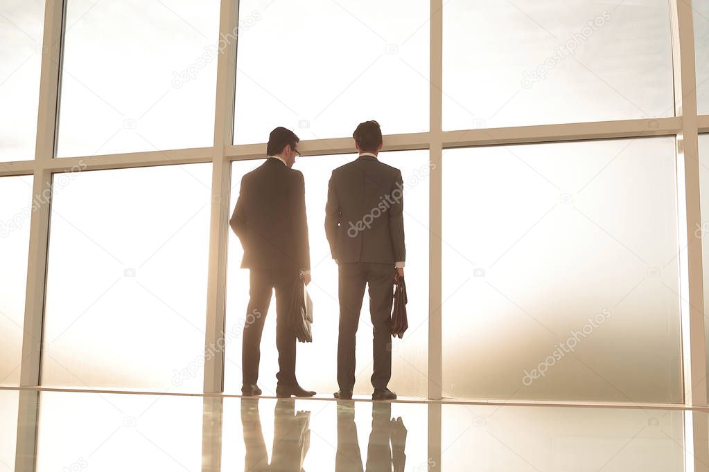business background.business partners look through the office window