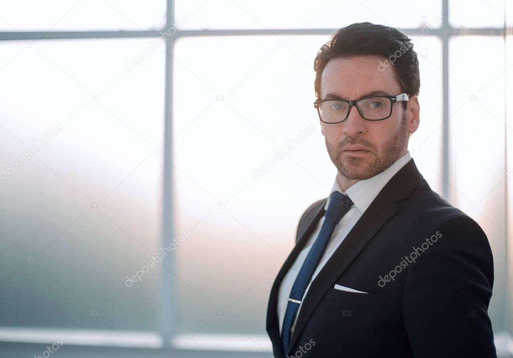 confident businessman on the background of the office window