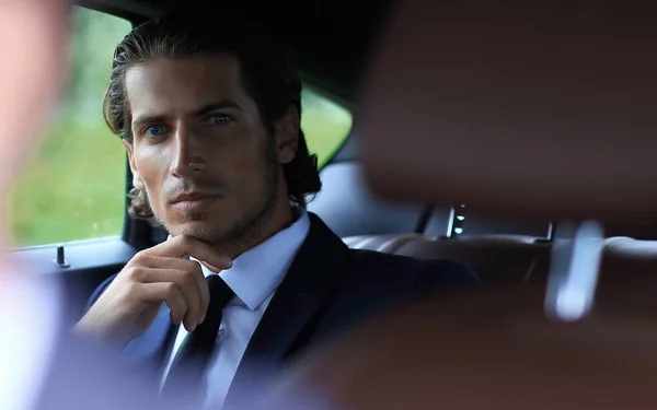 Businessman sitting in his car. — Stock Photo, Image