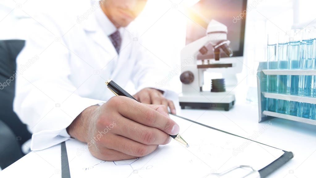 scientist makes a note of experiment in the laboratory