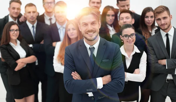 Homme d'affaires souriant debout sur le fond de son équipe d'affaires . — Photo