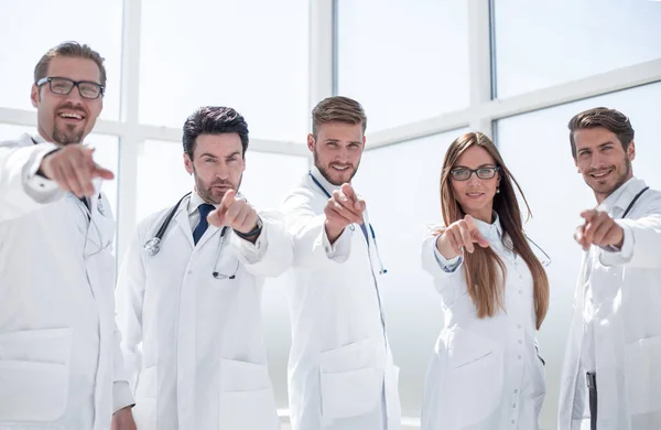 group of practicing doctors pointing their finger at you