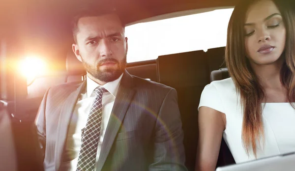 Successful people working together in back seat of car — Stock Photo, Image