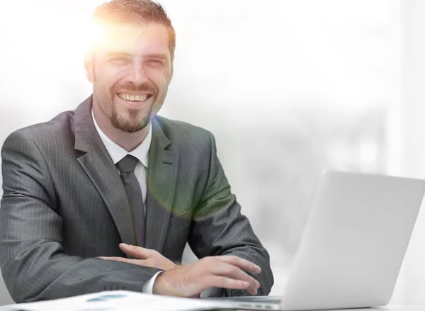 Closeup.smiling businessman working with laptop — Stock Photo, Image