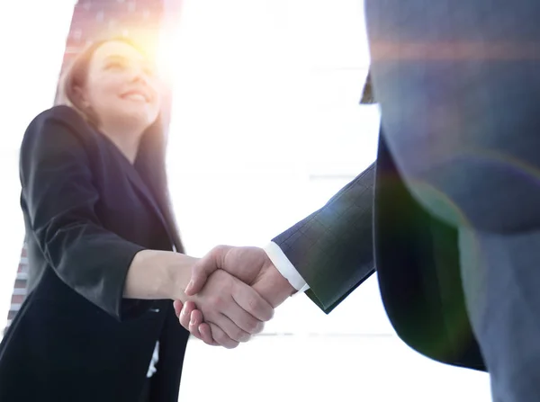 Close up of businessman and businesswoman shaking hands