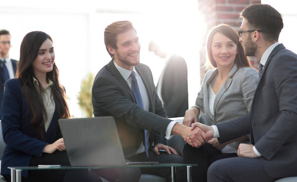 Successful partnership in business displayed by shaking hands in