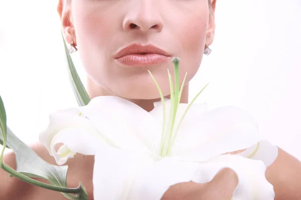 Young beautiful woman relaxing with flower at spa isolated — Stock Photo, Image