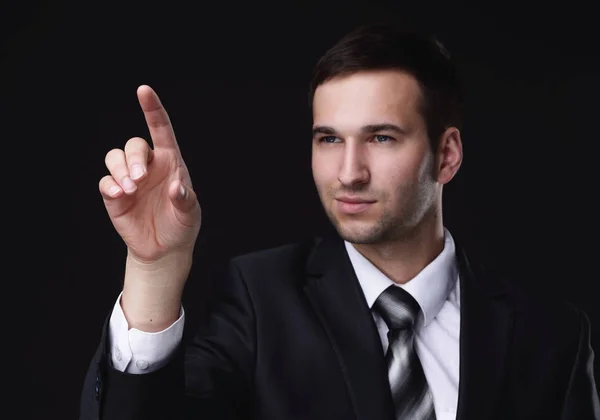 Businessman pointing to a blank spot.isolated on a black background. — Stock Photo, Image