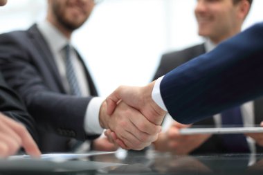 Business handshake. Close-up of business men shaking hands. clipart