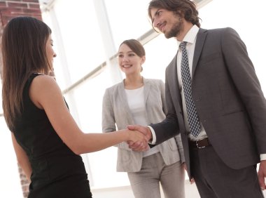 İş adamları geniş pencereli odaya karşı el sıkışıyor