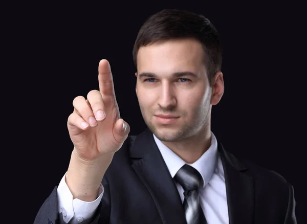 Geschäftsmann zeigt auf einen weißen Fleck auf schwarzem Hintergrund.. — Stockfoto