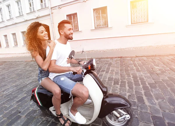 Full length side view of happy couple riding on retro motorbike — Stock Photo, Image