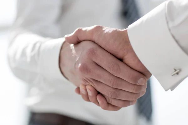 Close up.the young businessman shaking hands with a future partner — Stock Photo, Image