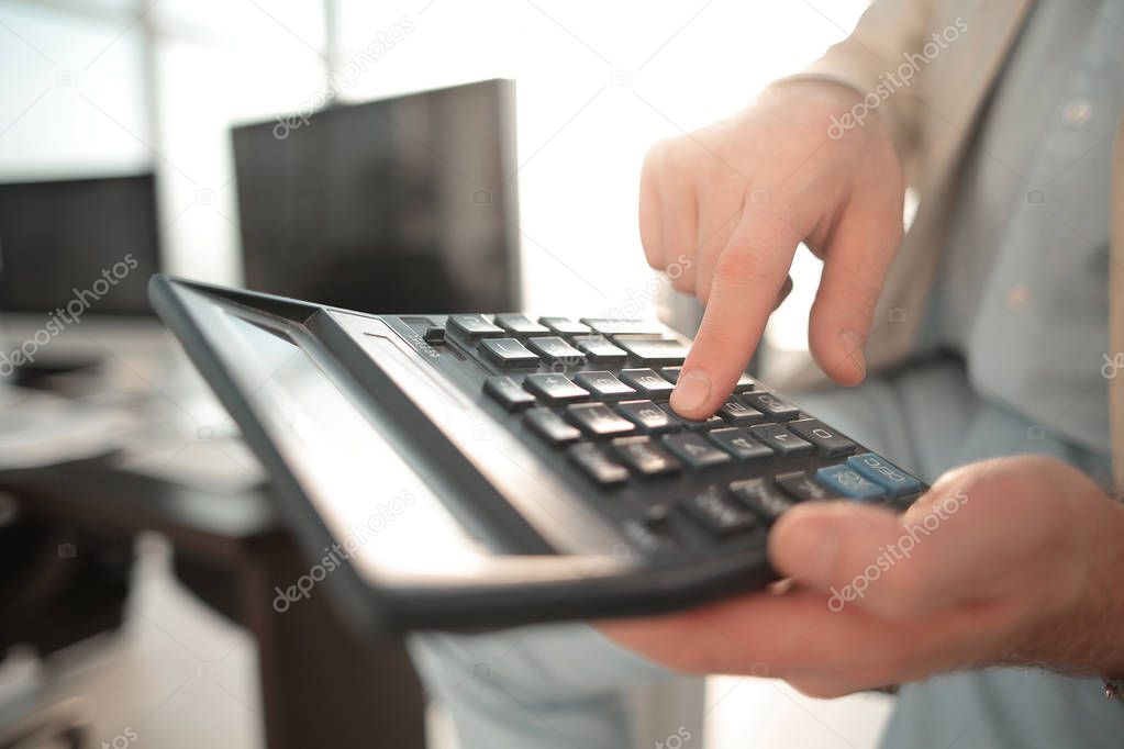 close up. businessman using calculator