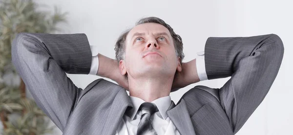 Closeup .a successful businessman relaxarea sitting behind a Desk — Stock Photo, Image