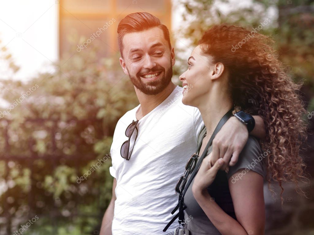 Cheerful young couple walking on urban street