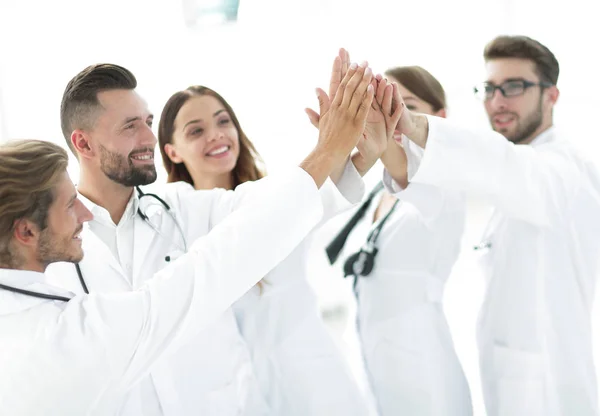 Group of doctors giving each other a high five. — Stock Photo, Image
