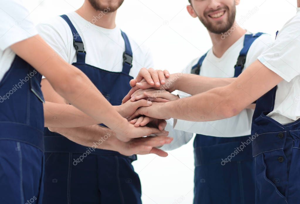 Team of movers joining hands.