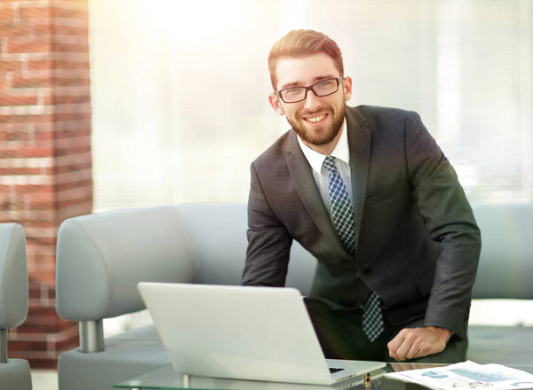 Portrait of a modern businessman sitting at his desk.