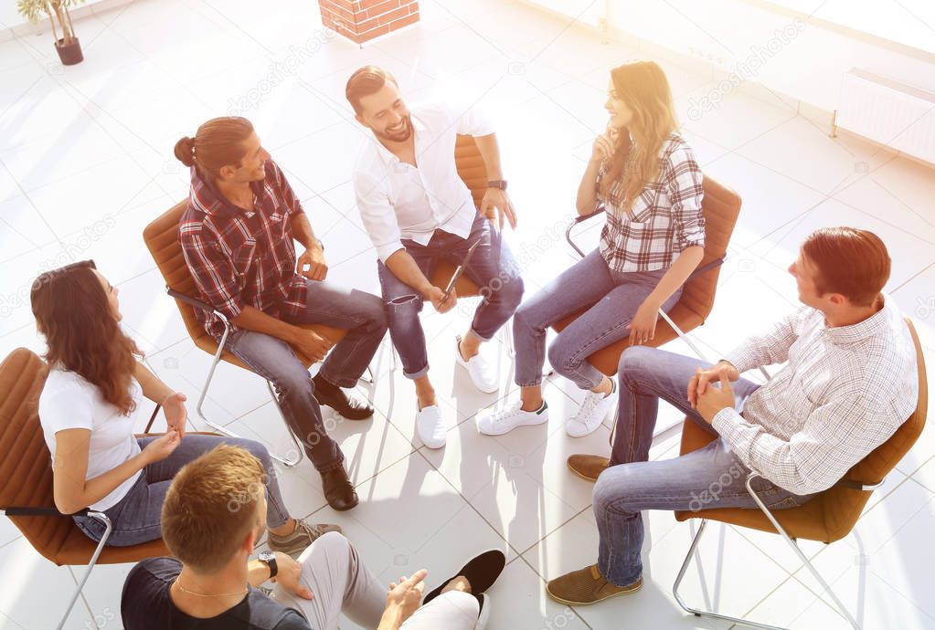 business team holds a meeting in the lobby of the office