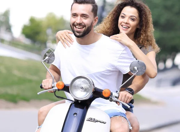 Happy couple driving scooter excited on summer holidays vacation
