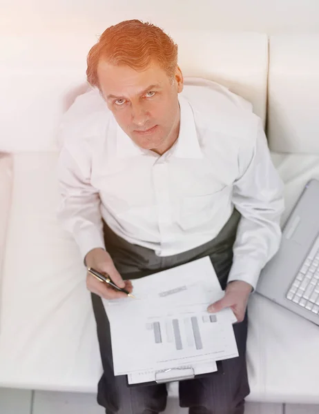 View from the top.businessman working with documents sitting on sofa — Stock Photo, Image