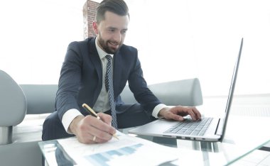 Dizüstü bilgisayarda çalışan ve Notlar not defterinde yapma şık adam