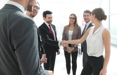İş kadını ve ofiste el sıkışan adam