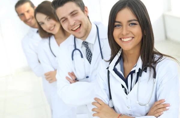 Female doctor with group of happy successful colleagues — Stock Photo, Image